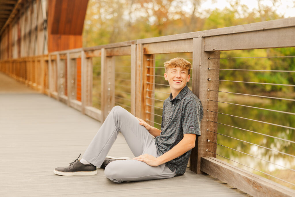Senior boy casual outfit senior portrait session at Bell Ford Bridge at Geist Park in Fortville, Indiana